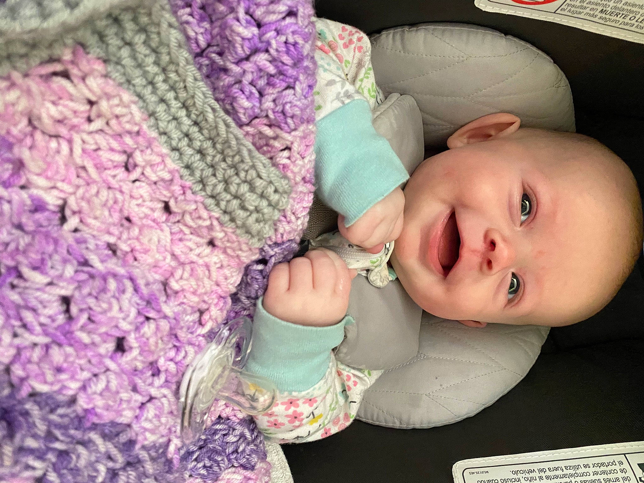 Jane is registered to the contest to win money with this photo: baby, baby_products, baby_toddler_clothing, cap, cheek, child, comfort, creative_arts, fashion_accessory, happy, headgear, iris, pattern, person, pink, purple, sleeve, smile, toddler, wool