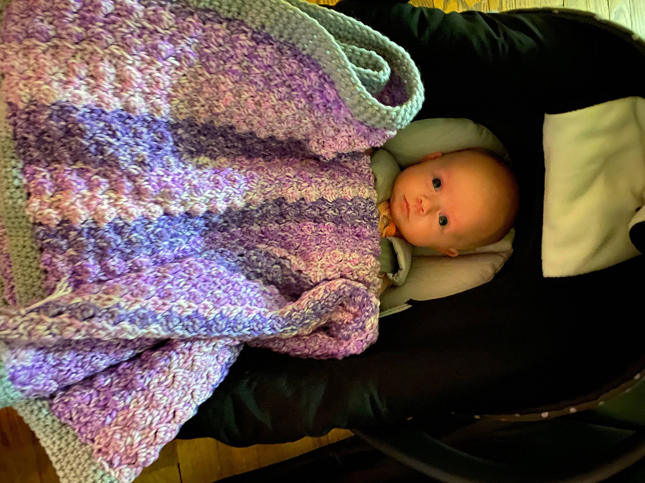 Jane is registered to the contest to win money with this photo: baby, baby_products, baby_toddler_clothing, cheek, comfort, creative_arts, electric_blue, eye, head, human_body, knit_cap, linens, pattern, purple, sleeve, textile, toddler, violet, wool, woolen