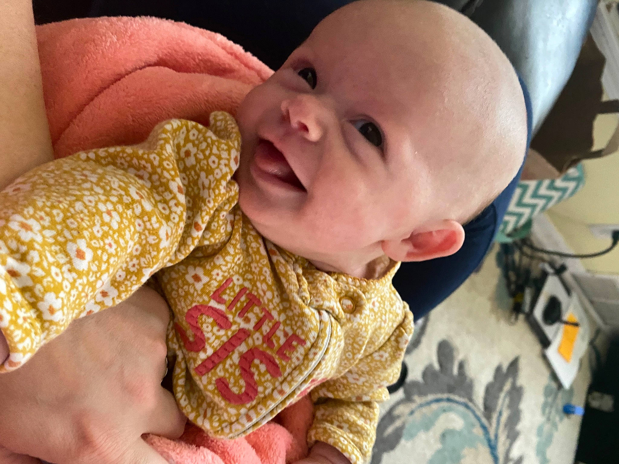 Jane is registered to the contest to win money with this photo: baby, baby_toddler_clothing, cheek, comfort, eye, finger, gesture, hand, happy, lip, mammal, mouth, nail, nose, person, skin, sleeve, smile, textile, thumb