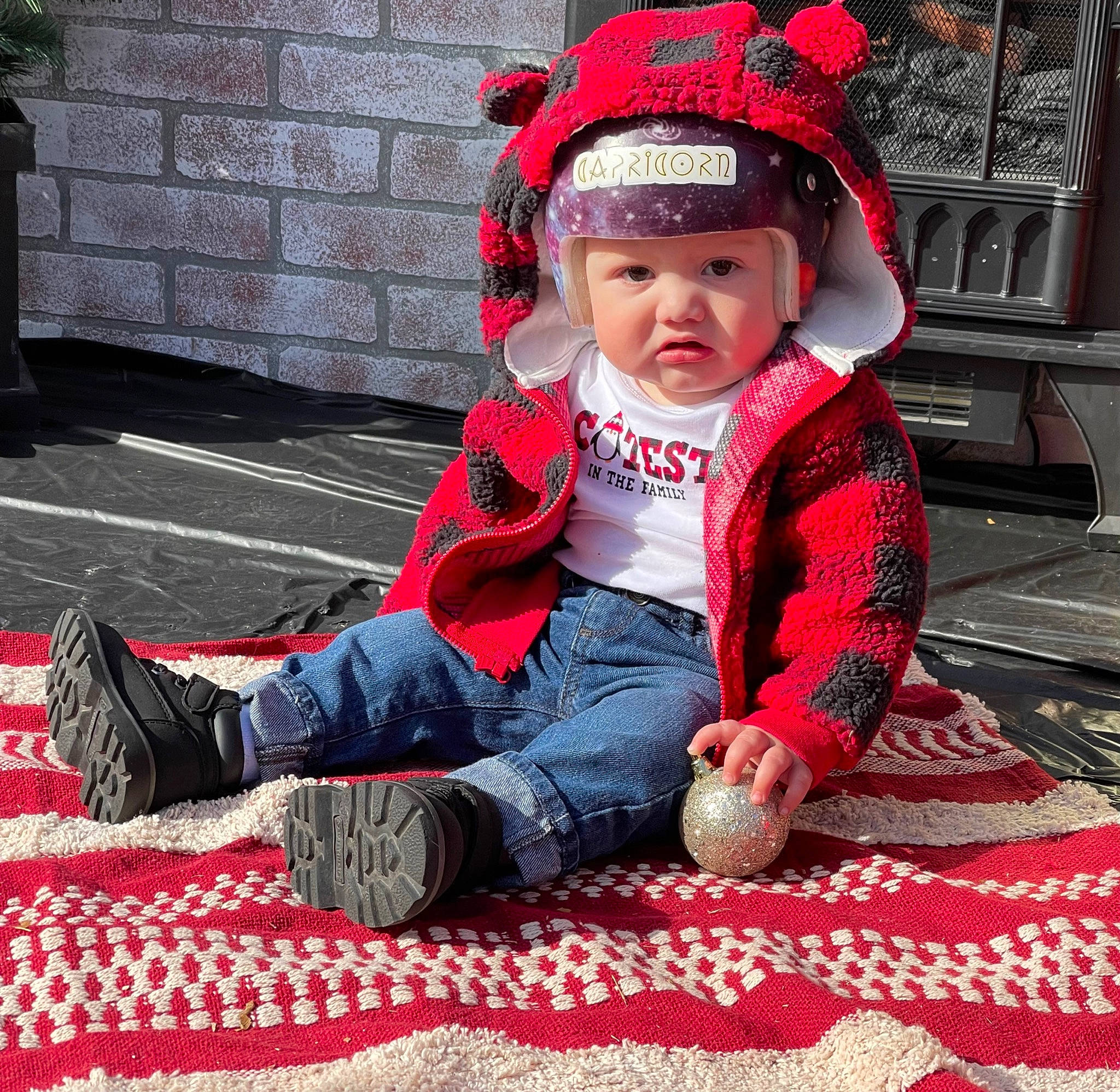 Marcellus joined the competition — help win amazing prizes! baby, baby_toddler_clothing, cap, carmine, child, cool, costume, flooring, fun, grass, happy, headgear, headwear, human_leg, pattern, person, plant, red, sitting, sleeve