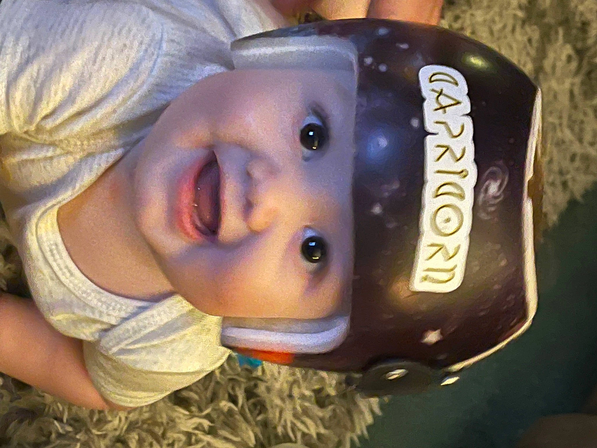 Marcellus is registered to the contest to win money with this photo: baby, chest, child, drink, drinkware, electric_blue, eyelash, fun, happy, hat, headwear, jaw, person, personal_protective_equipment, portrait_photography, smile, toddler, tree, water