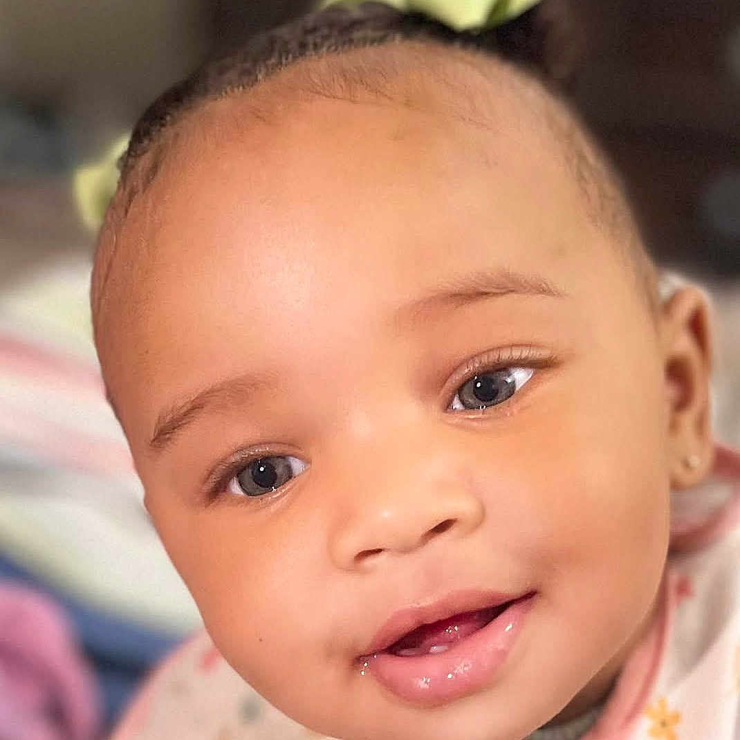 Beyon joined the competition — help win amazing prizes! adorable, apparel, baby, bib, cheeks, child, close_up, cute, expression, eyes, face, hair_bow, indoors, infant, mouth, person, portrait, skin, smile, young