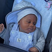 Enzo joined the competition — help win amazing prizes! baby, sleeping, hat, pom_poms, blanket, stroller, clothing, coat, keychain, unicorn, infant, peaceful, cute, soft, child, portrait, closeup, resting, indoor, cozy