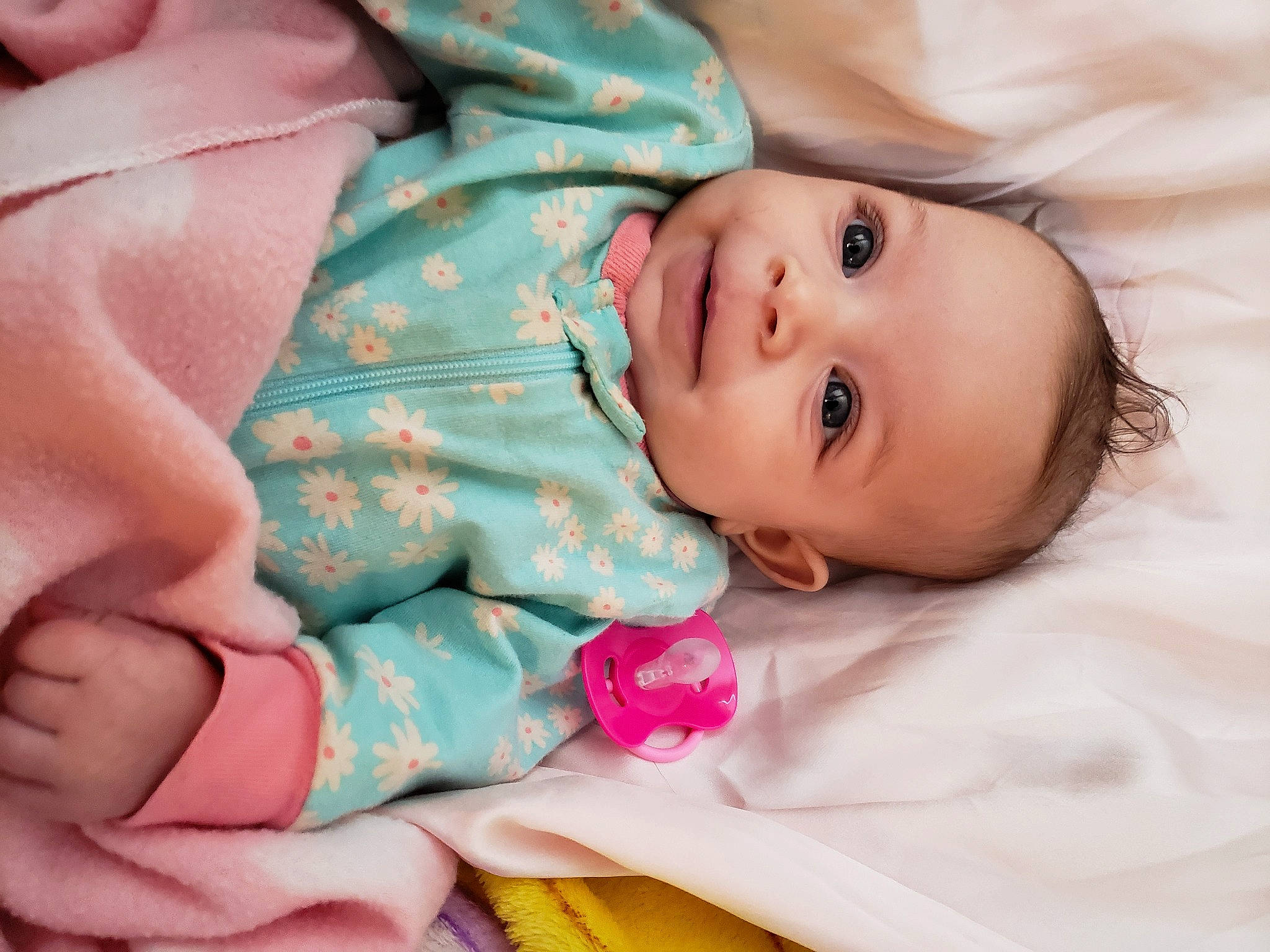 Makyah is registered to the contest to win money with this photo: baby, baby_toddler_clothing, cheek, child, comfort, eye, finger, gesture, hand, happy, iris, lip, mouth, nose, person, pink, product, skin, sleeve, toddler