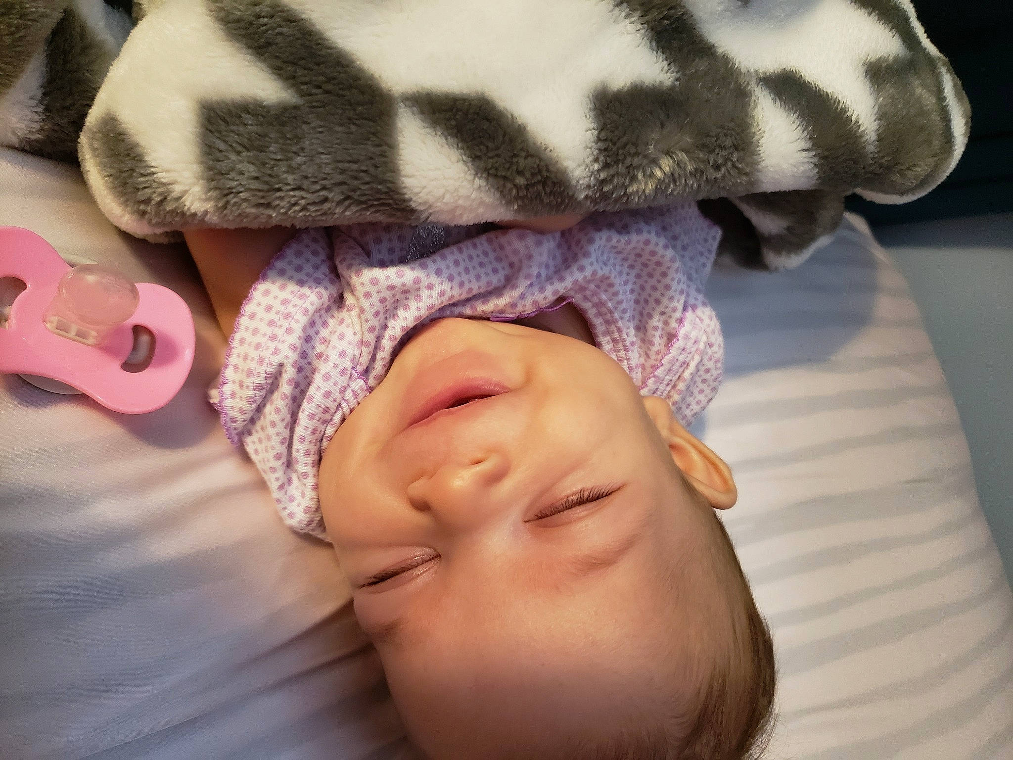 Makyah is registered to the contest to win money with this photo: baby, baby_products, baby_sleeping, baby_toddler_clothing, bedtime, cheek, comfort, eyebrow, fashion_accessory, finger, happy, headgear, knit_cap, linens, nose, person, pink, purple, skin, sleeve