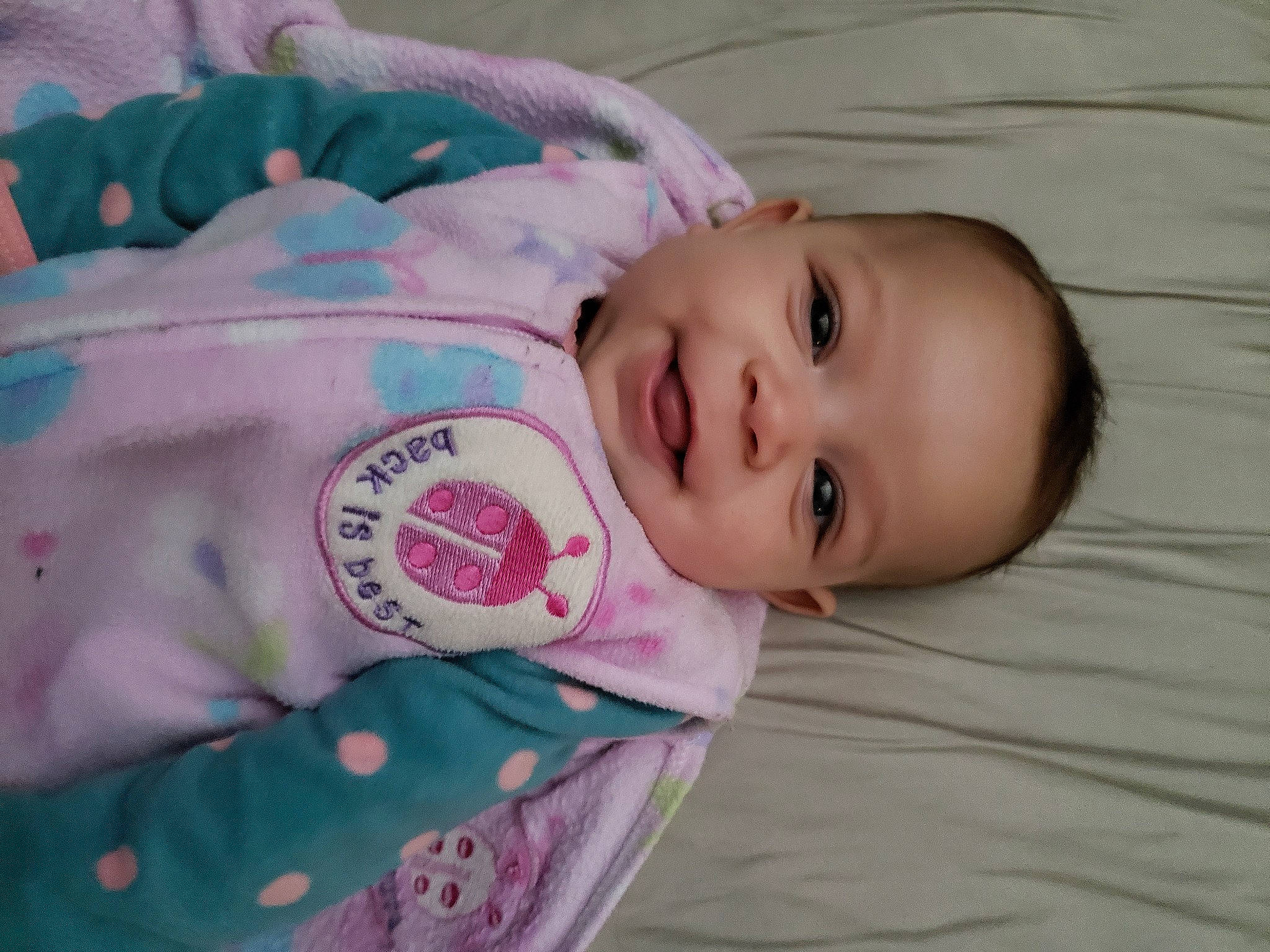 Makyah is registered to the contest to win money with this photo: baby, baby_products, baby_toddler_clothing, cheek, child, comfort, eye, happy, joy, linens, lip, magenta, pattern, person, pink, sitting, skin, sleeve, smile, textile