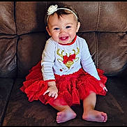 Kynslee is registered to the contest to win money with this photo: accessories, baby, bodypart, chair, clothing, couch, cushion, dress, face, finger, furniture, hand, happy, head, homedecor, person, photography, portrait, sitting, skirt