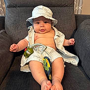 Lincoln joined the competition — help win amazing prizes! baby, infant, child, hat, clothing, toys, armchair, furniture, indoor, cute, smiling, relaxed, chubby, legs, feet, shirt, shorts, pattern, fabric, person