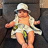 baby, infant, child, hat, clothing, toys, armchair, furniture, indoor, cute, smiling, relaxed, chubby, legs, feet, shirt, shorts, pattern, fabric, person