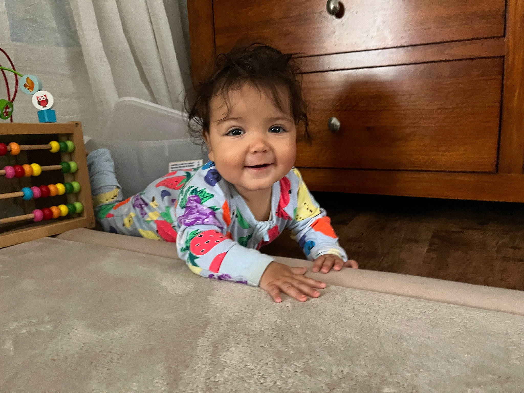 Ava joined the competition — help win amazing prizes! baby, baby_toddler_clothing, cabinetry, cheek, crawling, drawer, eye, face, floor, flooring, fun, happy, hardwood, head, person, product, sitting, smile, standing, toddler