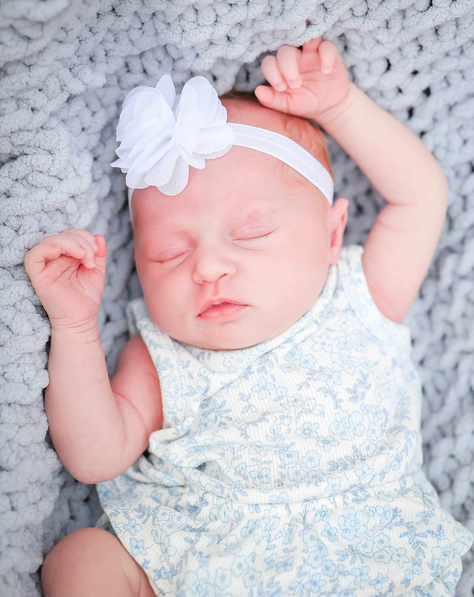 Delilah joined the competition — help win amazing prizes! baby, infant, sleeping, headband, flower, blanket, knit, soft, cute, peaceful, child, newborn, clothing, blue_flower_pattern, skin, face, arms, closed_eyes, resting, portrait