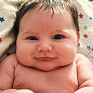 Cruz is registered to the contest to win money with this photo: baby, infant, smile, face, cheeks, skin, hair, blanket, pattern, stars, closeup, portrait, cute, child, newborn, happy, indoors, soft, expression, human
