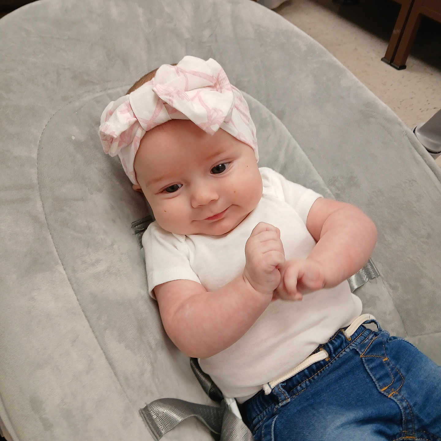 Ileana joined the competition — help win amazing prizes! baby, baby_seat, blue_jeans, bow, child, clothing, comfort, cute, floor, gray, hands, headband, indoors, infant, person, portrait, relax, smile, white_shirt, young