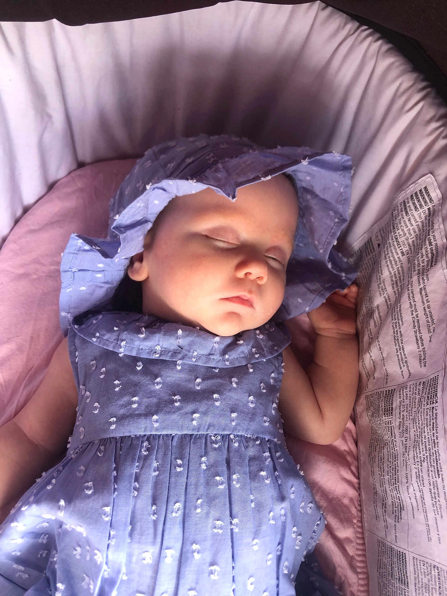 Ivy is registered to the contest to win money with this photo: baby, sleeping, blue_dress, bonnet, infant, cushion, pink_blanket, face, peaceful, child, soft_lighting, indoors, portrait, resting, cute, newborn, clothing, headwear, closeup, young_child
