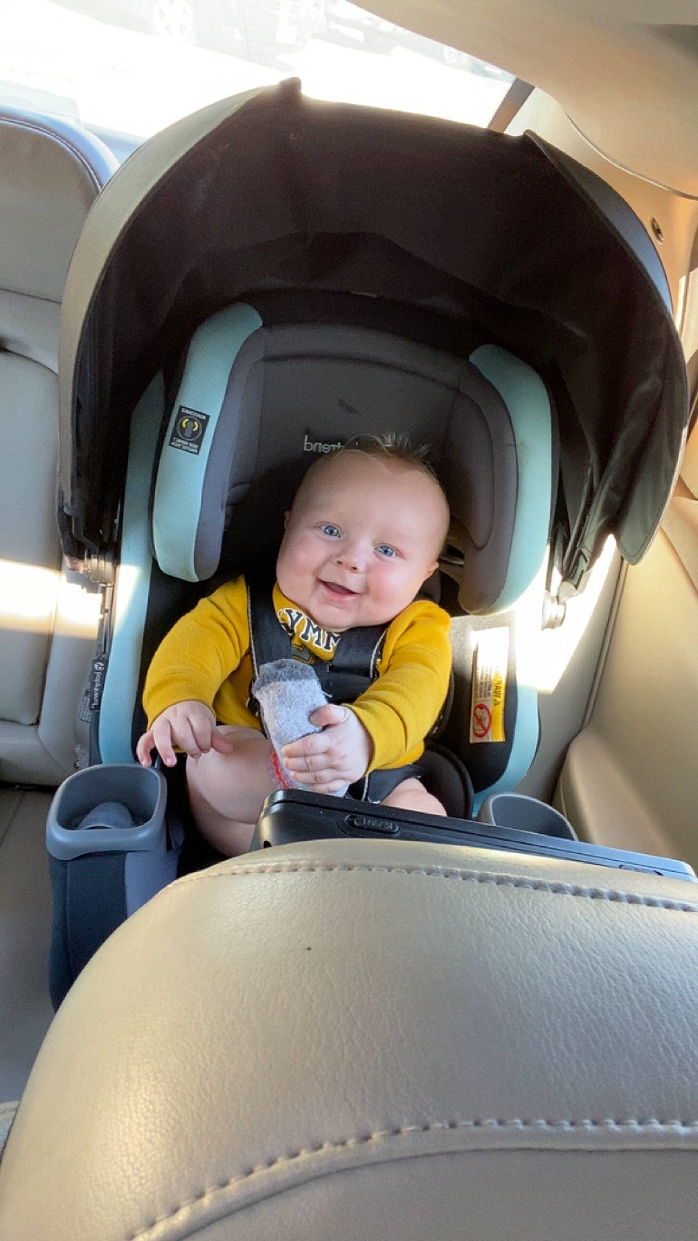 Levi is registered to the contest to win money with this photo: auto_part, automotive_design, automotive_exterior, baby_carriage, baby_in_car_seat, car, car_seat, car_seat_cover, comfort, family_car, head_restraint, joy, mode_of_transport, motor_vehicle, person, product, seat_belt, smile, steering_wheel, toddler
