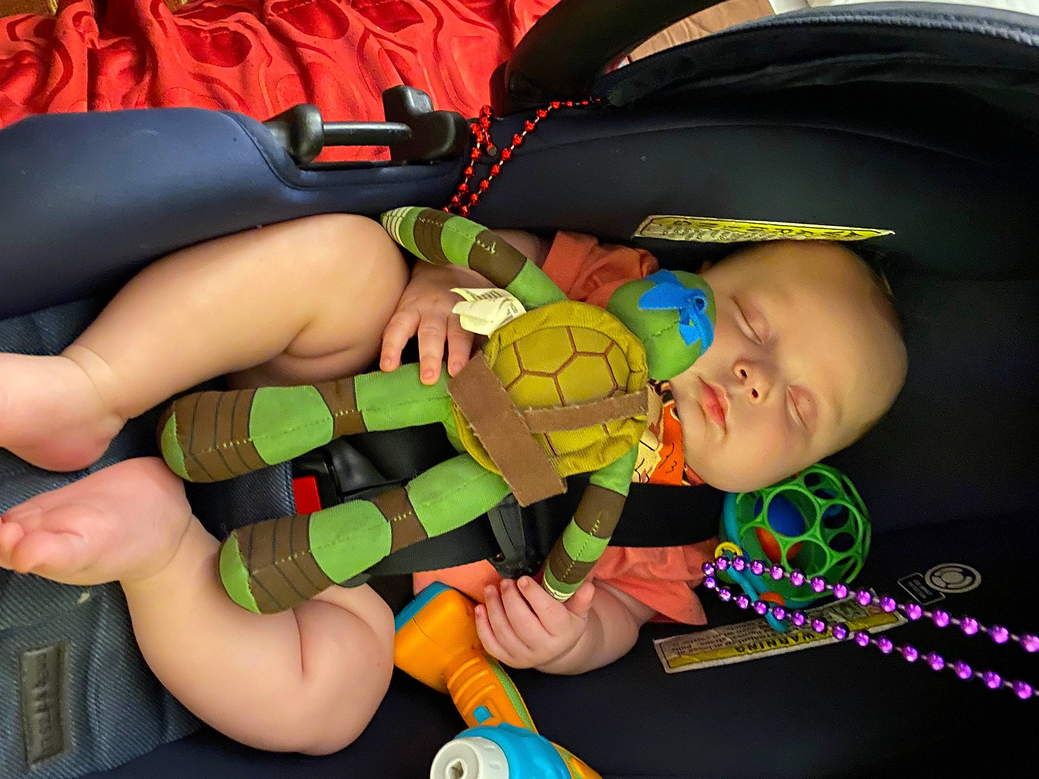 Levi is registered to the contest to win money with this photo: baby, baby_products, baby_toddler_clothing, child, comfort, finger, fun, human_leg, knee, lap, leg, mouth, nail, person, personal_protective_equipment, sitting, thigh, thumb, toddler, toy