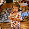 area_rug, cabinet, child, colorful_clothing, door, furniture, girl, happy, home, indoors, living_room, pajamas, photography, playful, portrait, shoes, smiling, standing, toddler, wood_floor