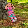 Sophia joined the competition — help win amazing prizes! child, family_activity, forest, grass, happy, nature, outdoor, patterned_clothing, pink_shirt, playful, playground, portrait, ropes, sitting, smiling, sunlight, swing, toddler, tree, wooden_swing