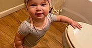Sophia joined the competition — help win amazing prizes! baby, bathroom, bathtub, bow, child, clothing, cute, happy, headband, indoor, infant, onesie, person, portrait, smiling, standing, toddler, toilet, walking, wooden_floor