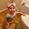 baby, bathroom, bathtub, bow, child, clothing, cute, happy, headband, indoor, infant, onesie, person, portrait, smiling, standing, toddler, toilet, walking, wooden_floor