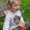 Sophia joined the competition — help win amazing prizes! blonde_hair, child, daylight, face, fence, garden, girl, grass, ice_cream_cup, leggings, leopard_print, outdoor, playground, portrait, sitting, smiling, sweatshirt, toddler, toy, wood_chips