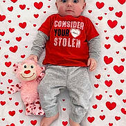 Colt joined the competition — help win amazing prizes! baby, infant, child, blue_eyes, red_shirt, grey_pants, plush_toy, stuffed_monkey, heart_pattern, heart_blanket, lying_down, top_view, portrait, cute, adorable, fabric, bare_feet, hands, clothing, gaze_direct