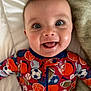 Colt is registered to the contest to win money with this photo: baby, infant, face, smile, blue_eyes, long_eyelashes, cheeks, tongue, onesie, sports_pajamas, pattern, closeup, portrait, bed, blanket, soft_texture, hand, joyful, cute, happy