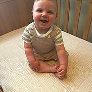 Xander-Richie is registered to the contest to win money with this photo: baby, babylaughing, bed, clothing, crib, cushion, face, furniture, happy, head, homedecor, indoors, infantbed, laughing, pants, person, photography, portrait, sitting, smile
