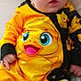 Ashen joined the competition — help win amazing prizes! baby, child, infant, yellow, duck, pajamas, hat, clothing, cute, face, person, sitting, indoors, soft, cozy, cartoon, animal_print, footwear, hand, portrait