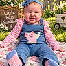 baby, child, infant, smiling, happy, portrait, outdoor, garden, flowers, daisies, headband, bow, overalls, pink, blue, socks, sitting, blanket, sunlight, wooden_sign