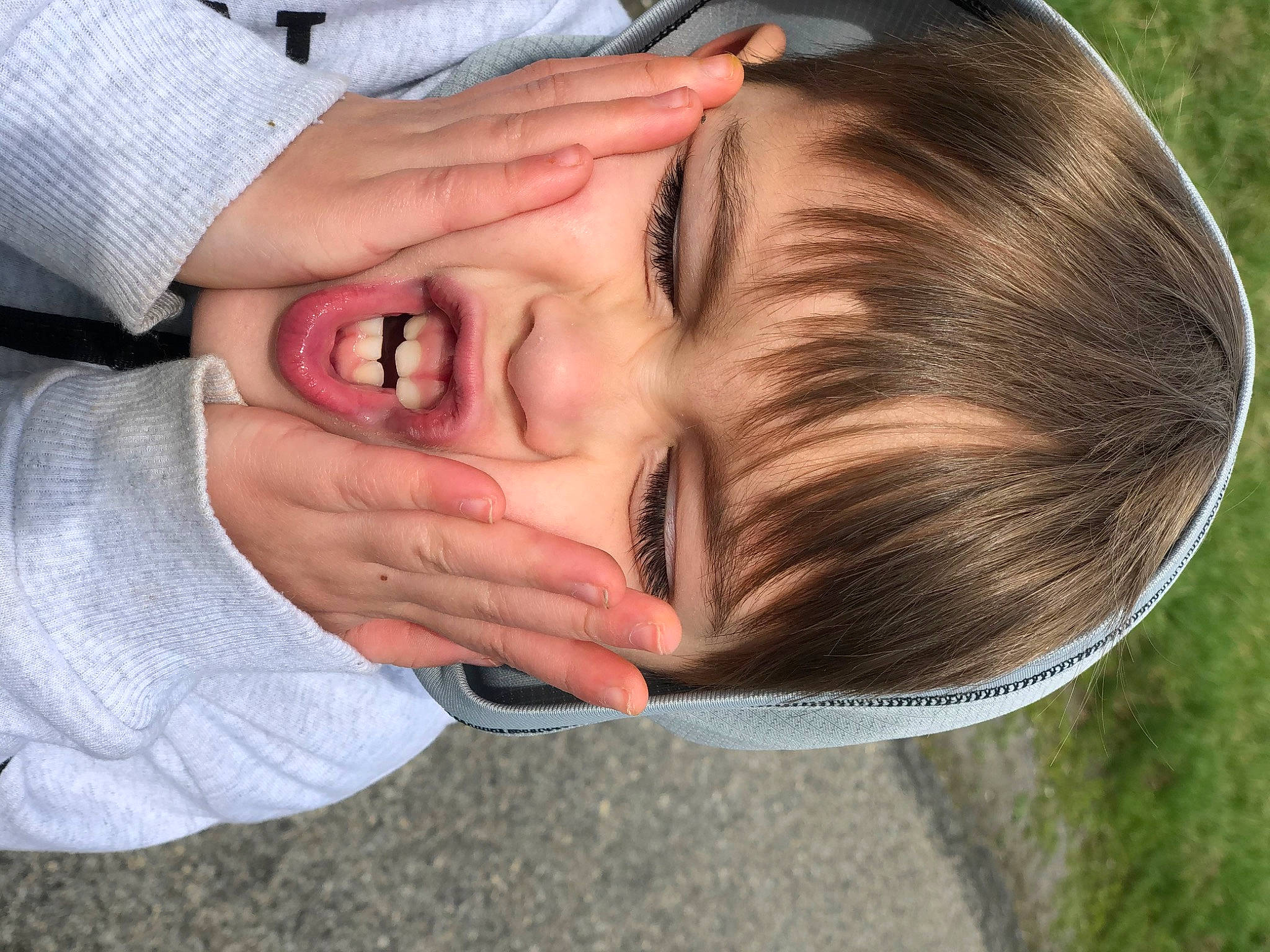 Gabriel is registered to the contest to win money with this photo: cheek, child, ear, eye, face, facial_expression, finger, forehead, fun, gesture, grass, hair, hand, happy, head, love, mouth, nose, person, skin