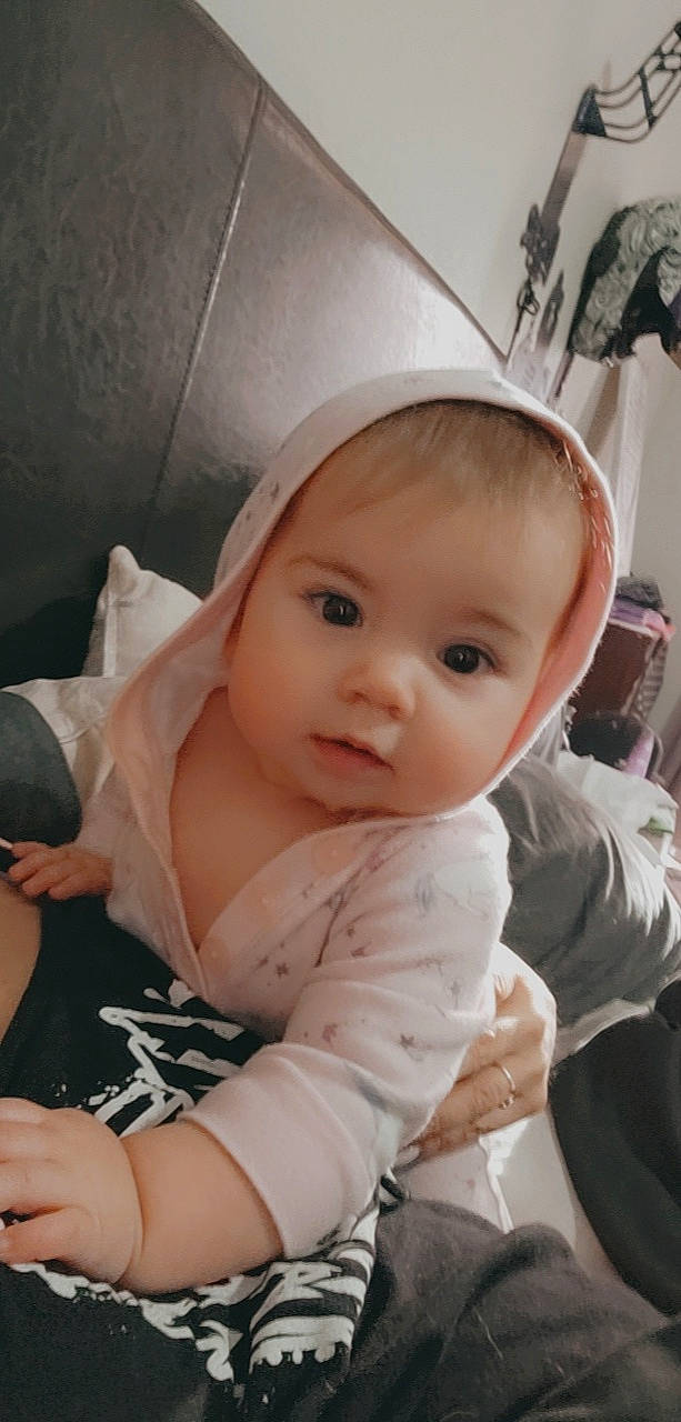 Fiona is registered to the contest to win money with this photo: arm, baby, baby_toddler_clothing, blond, cheek, child, comfort, dress, elbow, eyelash, finger, fun, hand, happy, iris, lip, person, pink, skin, sleeve