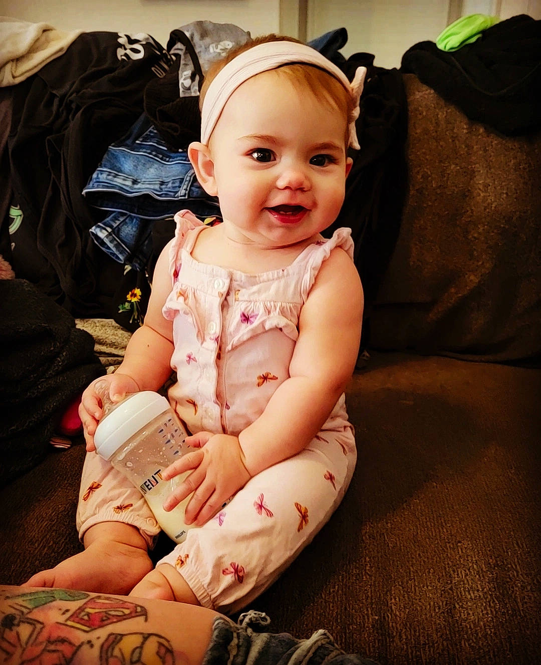 Fiona is registered to the contest to win money with this photo: baby, baby_toddler_clothing, cheek, child, comfort, couch, finger, flash_photography, happy, head, human_leg, joy, knee, lap, nail, person, sitting, skin, smile, thigh