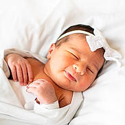 Alyana Ahmad joined the competition — help win amazing prizes! baby, newborn, sleeping, blanket, headband, white, soft, cute, peaceful, infant, skin, hand, face, portrait, indoors, lying_down, toddler, rest, closeup, child