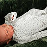 newborn, baby, sleeping, infant, portrait, onesie, swaddle, mitten, blanket, cozy, green_blanket, stars, indoors, closeup, peaceful, resting, lying_down, soft_lighting, child, nursery
