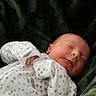 baby, newborn, sleeping, infant, portrait, indoors, blanket, plush, green, white, onesie, stars, bundled, peaceful, cute, face, closed_eyes, lying_down, cozy, photography
