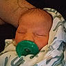 Nolan joined the competition — help win amazing prizes! newborn, baby, sleeping, pacifier, swaddled, blanket, portrait, close_up, face, eyes_closed, infant, cozy, indoors, cradled, tattoo, arm, green_pacifier, soft_lighting, peaceful, family