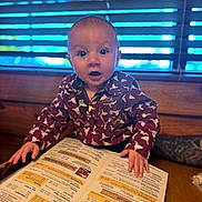Nolan joined the competition — help win amazing prizes! baby, child, infant, portrait, sitting, table, restaurant, menu, food, hands, wide_eyes, open_mouth, curious, patterned_clothing, onesie, indoor, window, blinds, wood, photography