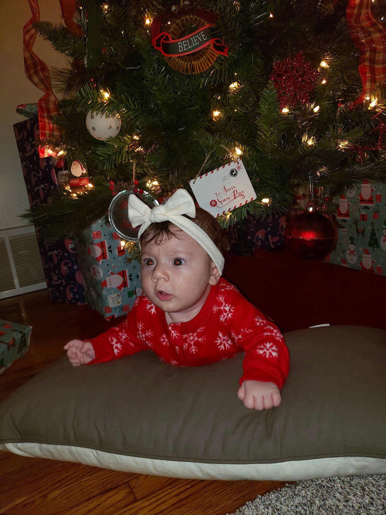 Caroline joined the competition — help win amazing prizes! child, christmas, christmas_decoration, christmas_eve, christmas_lights, christmas_ornament, christmas_tree, event, fir, headwear, holiday, holiday_ornament, interior_design, person, room, sitting, smile, toddler, tree