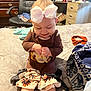 baby, child, smiling, bow, headband, bed, blanket, clothing, indoor, furniture, chair, drawer, happy, person, sitting, cute, infant, turkey_design, fabric, room
