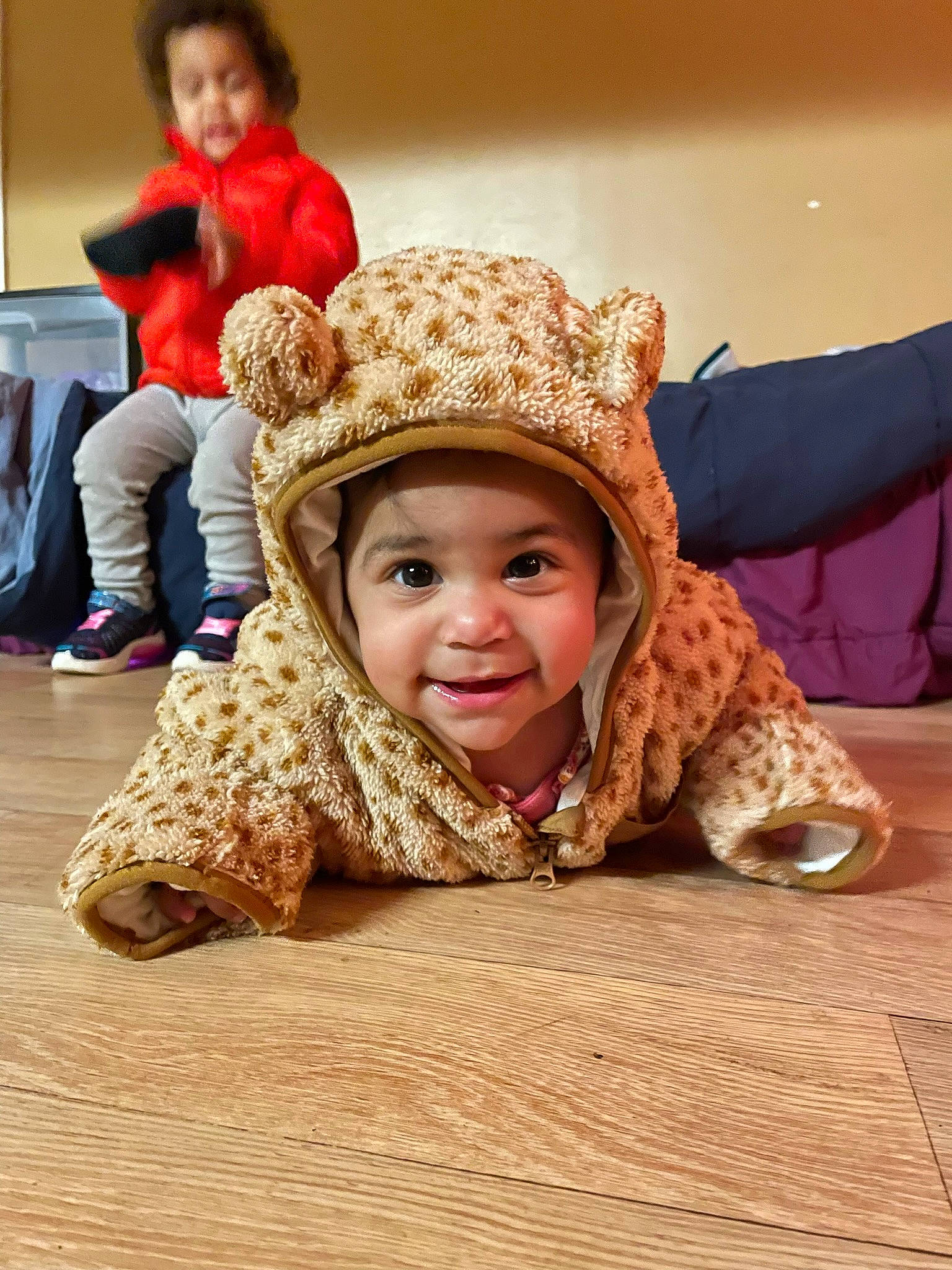 Aria is registered to the contest to win money with this photo: baby, cap, cheek, child, comfort, face, fashion_accessory, flash_photography, floor, flooring, fun, fur, happy, headwear, joy, leisure, people, person, portrait_photography, sitting