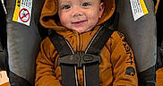 Rowen joined the competition — help win amazing prizes! baby, child, car_seat, hoodie, smile, face, infant, clothing, seatbelt, safety, happy, cute, indoor, person, young_child, hands, eyes, expression, jacket, seat