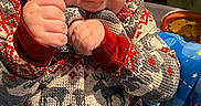 Rowen joined the competition — help win amazing prizes! baby, baby_seat, blue, chewing, child, colorful, cute, expression, face, festive_clothing, hands, head, indoor, infant, lock_screen_overlay, patterned_clothing, portrait, red, seat, sweater
