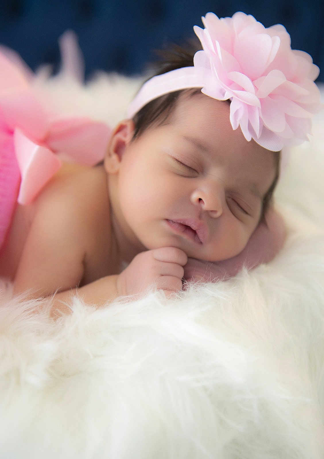 Charlotte is registered to the contest to win money with this photo: baby, newborn, sleeping, headband, pink_flower, fluffy_blanket, soft_texture, closeup, portrait, infant, peaceful, cute, resting, skin, hand, face, indoors, cozy, adorable, child