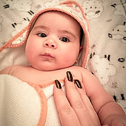 Aiyah joined the competition — help win amazing prizes! baby, towel, hand, nails, blanket, hood, face, skin, infant, soft, cute, child, person, closeup, indoors, comfort, warm, sleep, rest, expression