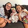 baby, bracelets, casual_clothing, child, colorful_shorts, couch, cute, dress, family, glasses, hand_gesture, happy, headband, indoors, long_hair, love, portrait, seated, siblings, smile