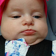 Presley joined the competition — help win amazing prizes! baby, child, headband, pink, car_seat, straps, close_up, face, serious_expression, clothing, floral_pattern, infant, person, cute, portrait, seatbelt, young, indoors, apparel, baby_girl