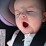 Presley is registered to the contest to win money with this photo: baby, car_seat, yawning, infant, child, harness, seatbelt, clothing, purple, gray, cute, animal_print, sleepy, indoors, car, safety, closeup, person, young, transportation