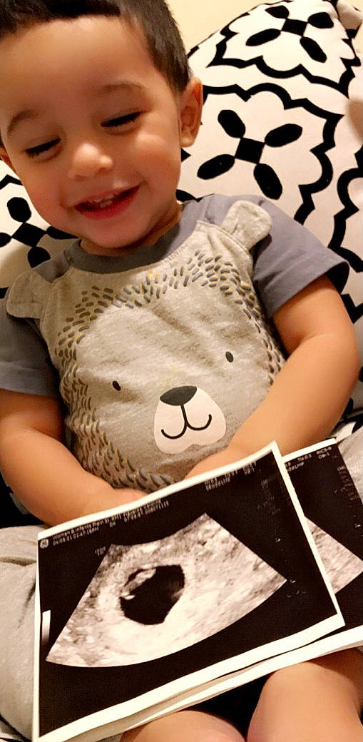 Dominic is registered to the contest to win money with this photo: baby, baby_toddler_clothing, beauty, black, cheek, cool, happy, headgear, joy, mammal, nose, organ, person, photograph, skin, sleeve, smile, t_shirt, textile, toddler