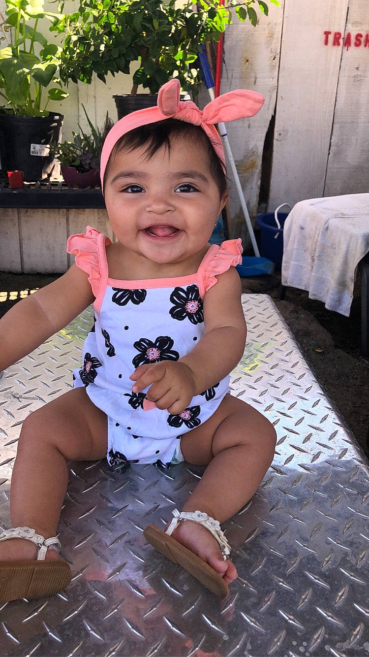 Alyson is registered to the contest to win money with this photo: baby, baby_toddler_clothing, child, fashion_accessory, hair_accessory, headgear, joy, person, pink, skin, toddler, vacation